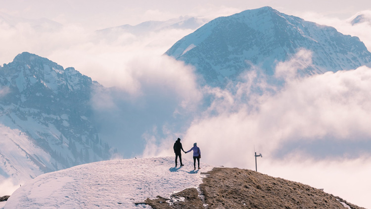 two people on a snowy summit