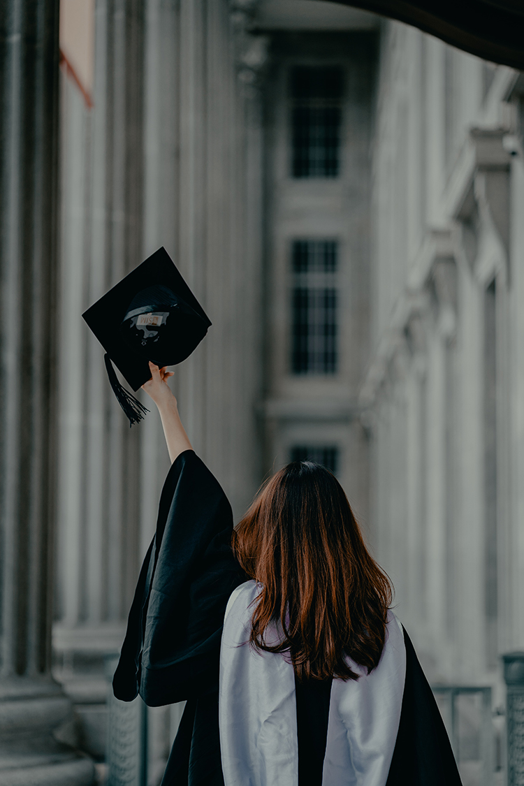 Grad raising mortarboard